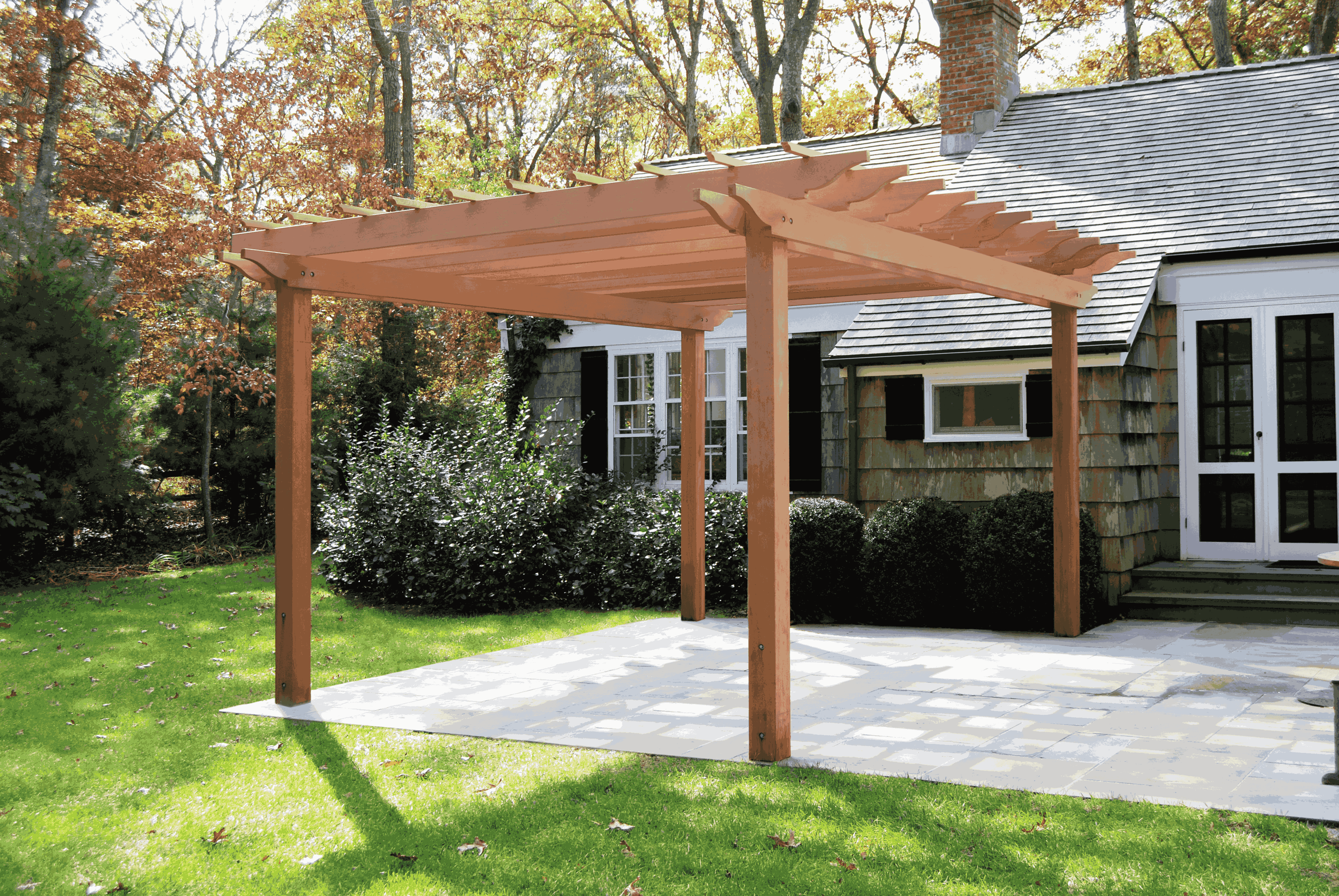 White pergola in garden setting with landscaping
